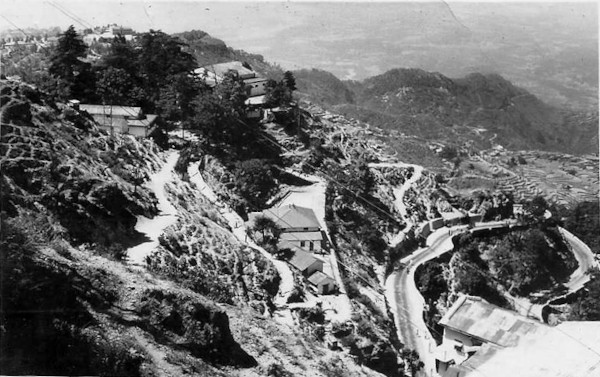 The view from Fern Lodge during winters in Mussoorie. The hill sides are covered in snow. Doon Valley and the Shivaliks are visible in the distance.