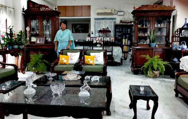 The living room of the meadow bungalow showcases Shanti's love of lace, crystal, pottery and indoor plants.